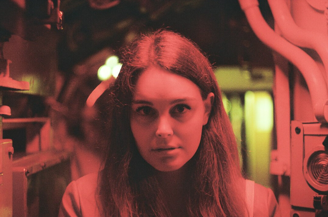Studio portrait of a Croatian female data engineer with shoulder length hair